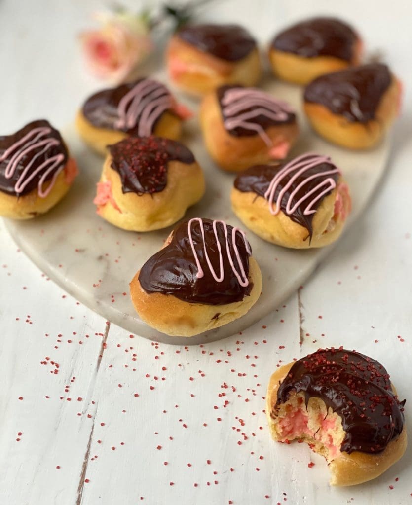 Pink cream filled chocolate covered doughnuts Pure Maple